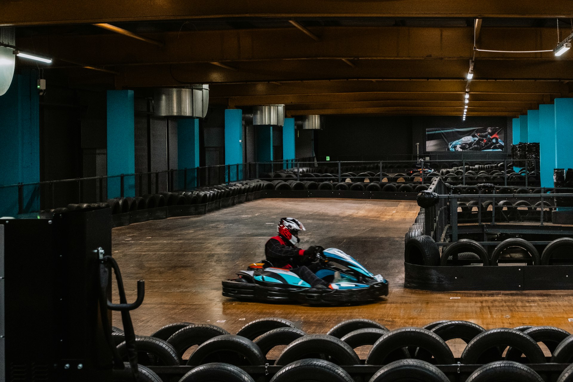 a person riding a go kart in a building